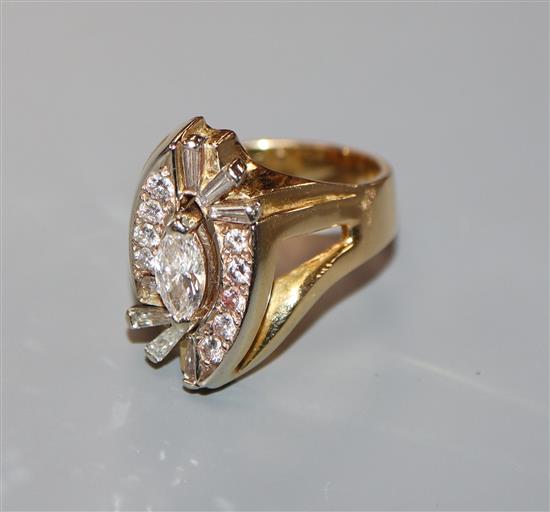 A modern 18k yellow metal, marquise, round and trapeze cut diamond set dress ring, size R/S.